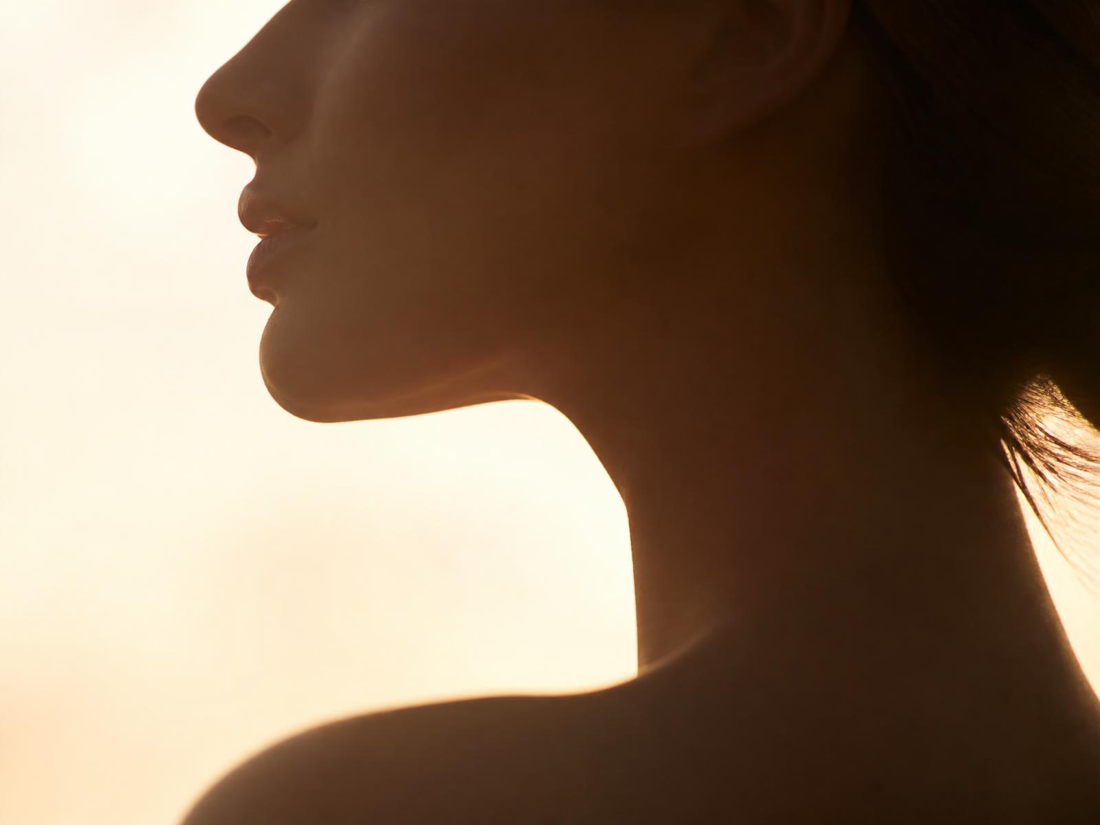 Soft backlit profile of a jawline and neck